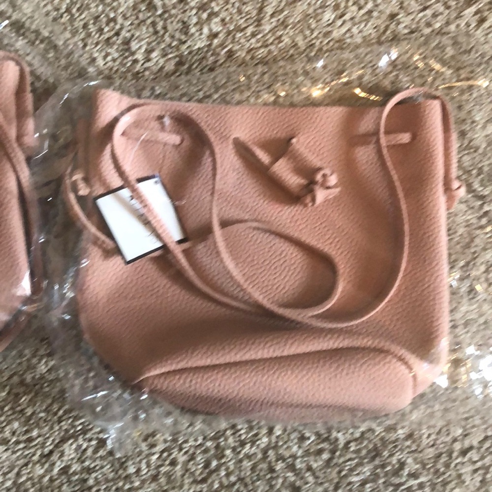 Macy’s pale pink drawstring handbag